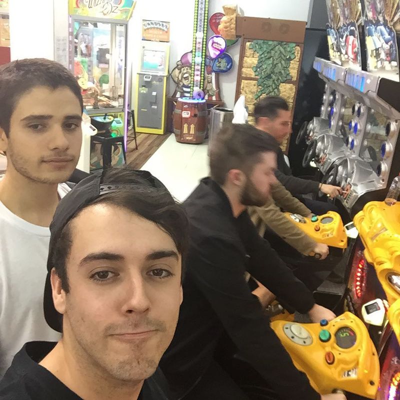 Arcade selfie with Dom Dolla and Torren Foot on racing machines behind