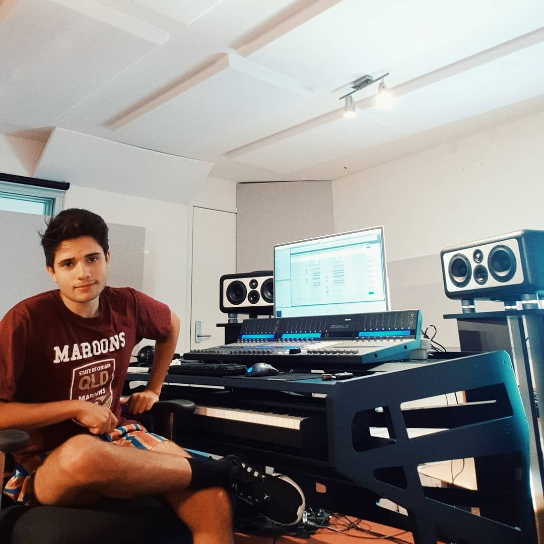 Harry Hope in a Maroons shirt at a mixing desk in an acoustically treated studio