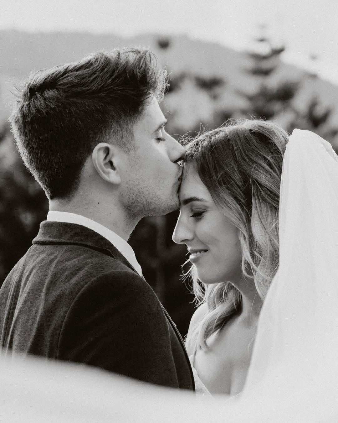 Black and white photo of Harry Hope kissing his bride on the forehead